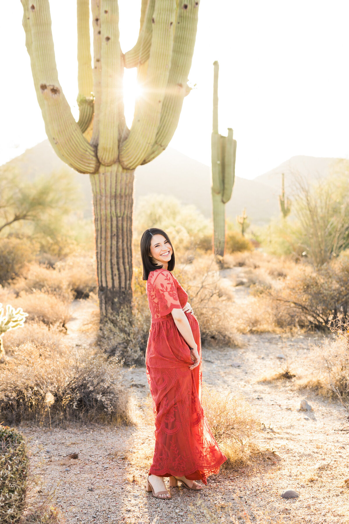 pregnant woman smiling for Scottsdale desert maternity photo session