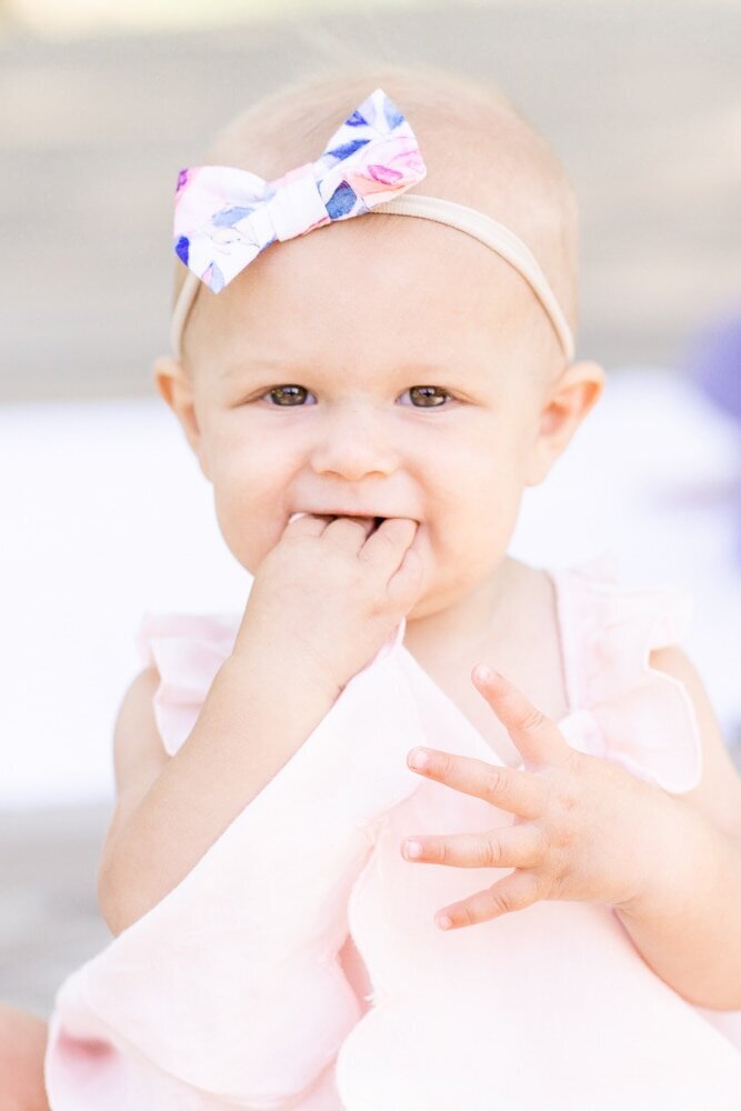 baby girl playing with hands during Ashburn, Virginia family photography