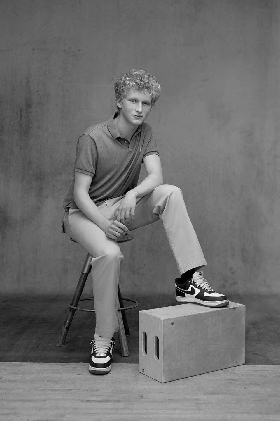 senior-guy-in-sneakers-with-studio-set