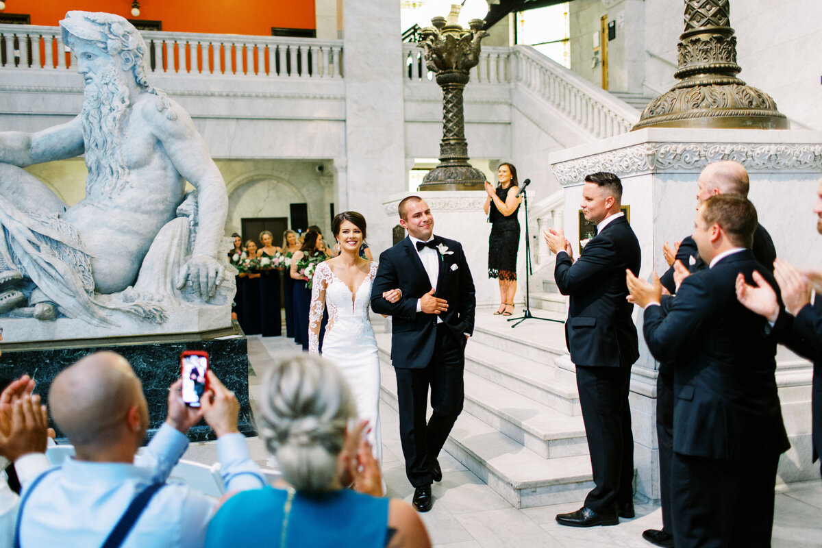 Just married, bride and groom walking out at  Minneapolis city hall wedding