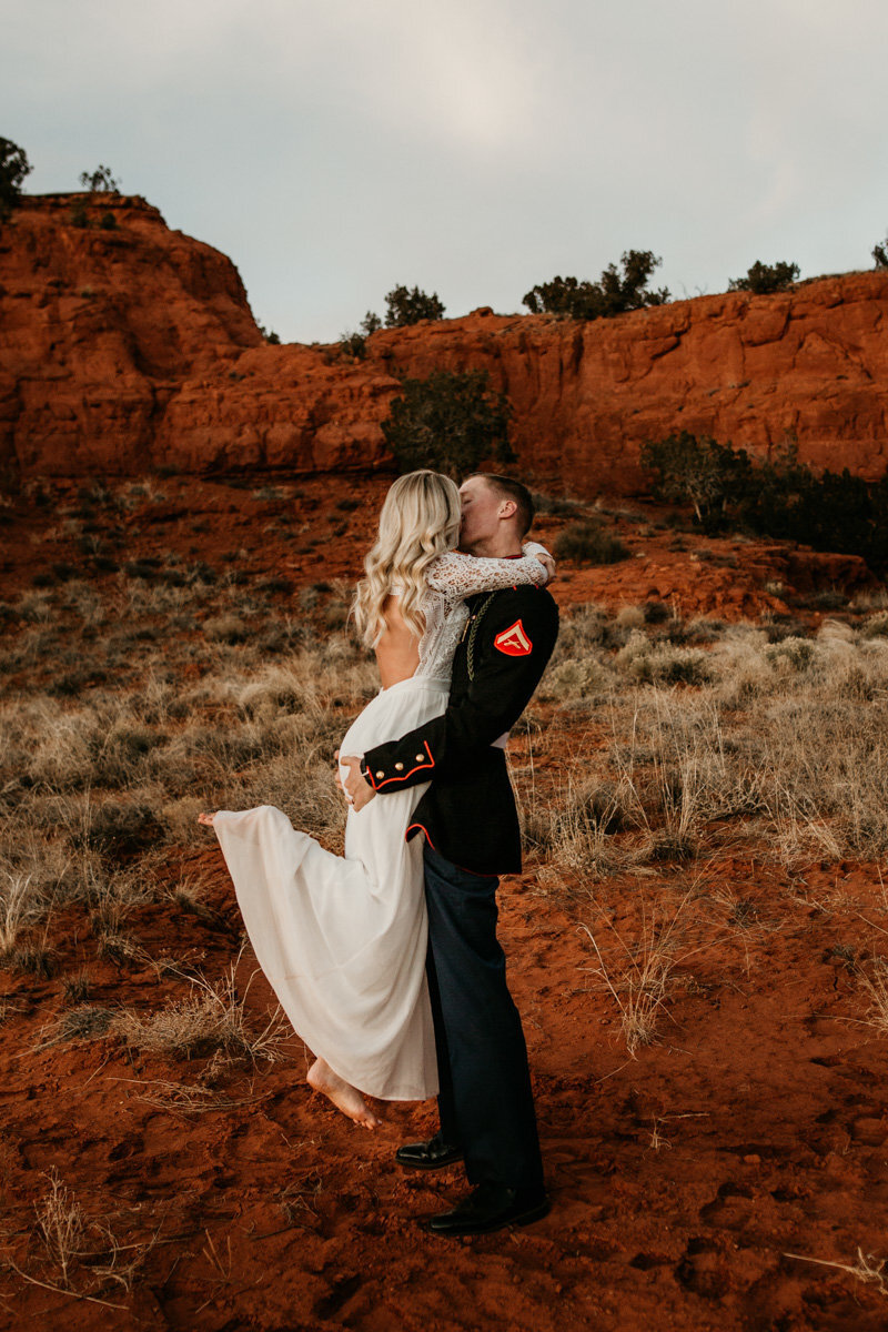 newlyweds kissing in the red desert