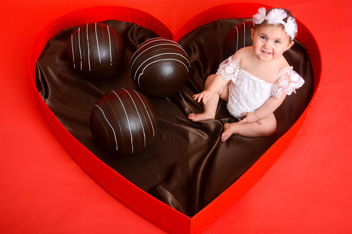 girl smiles at her girly first birthday photoshoot in houston