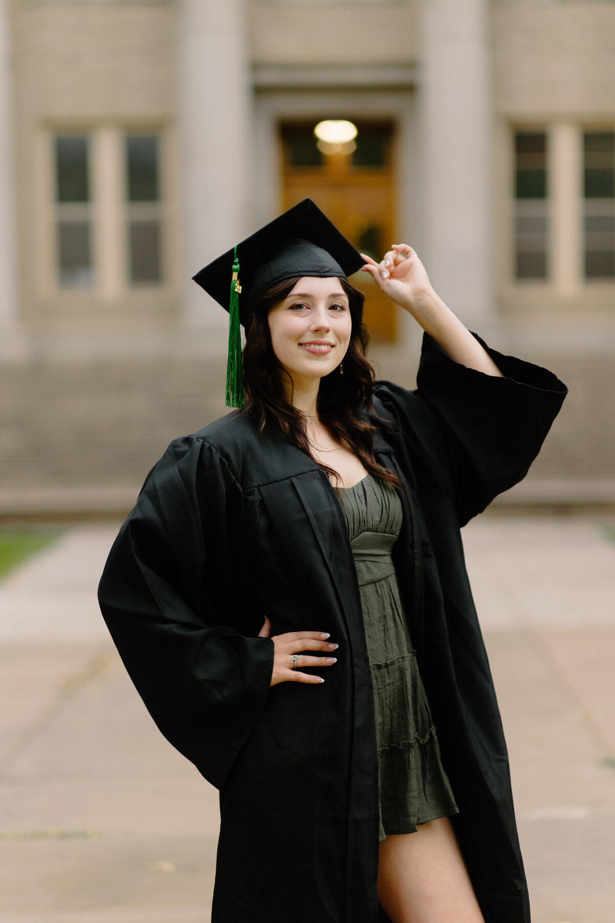 A Colorado State University graduate poses on The Oval in Fort Collins, Colorado.