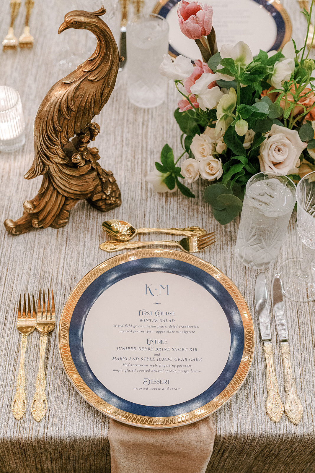 place setting with round menu and gold flatware