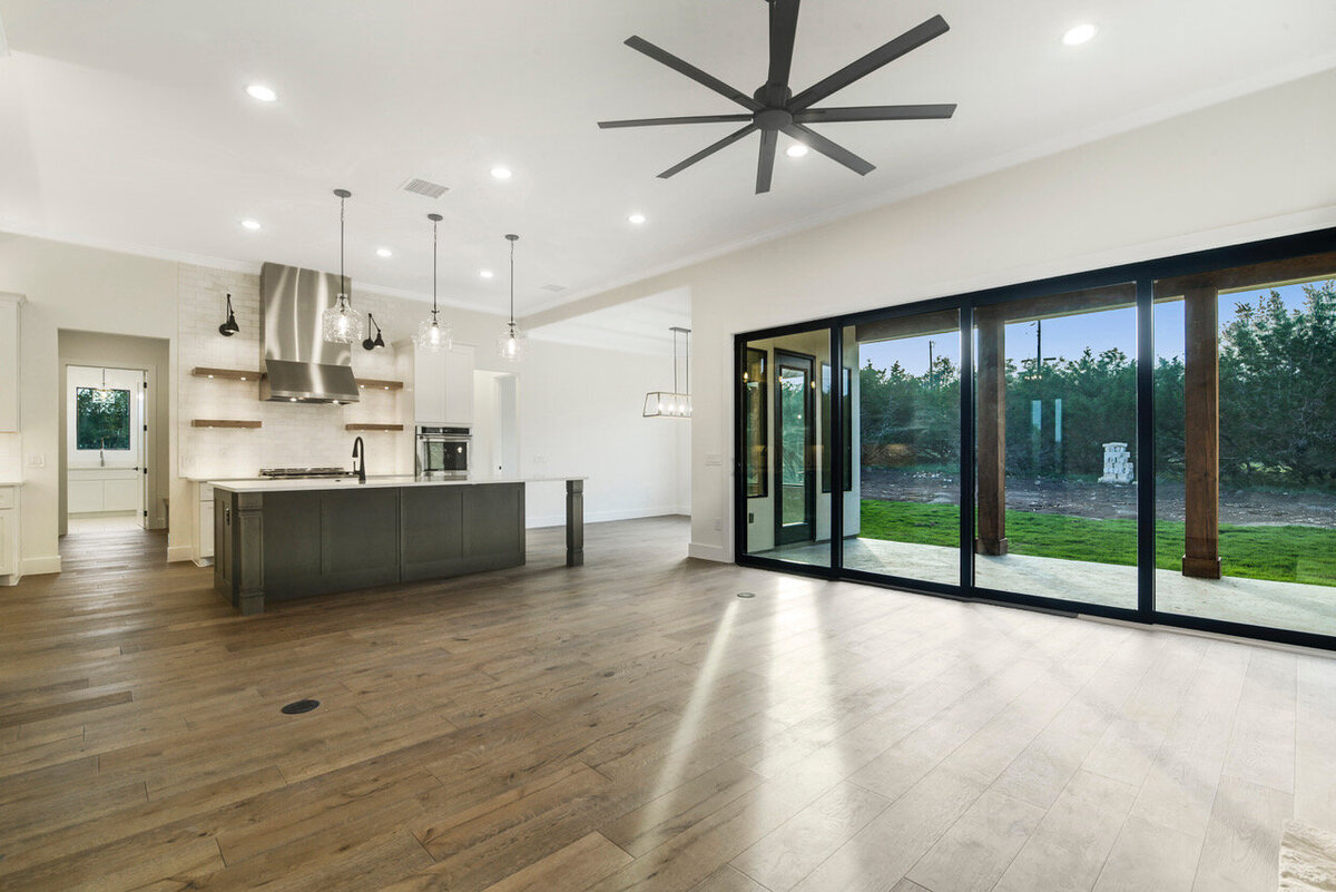 black sliding glass doors to back porch from living room