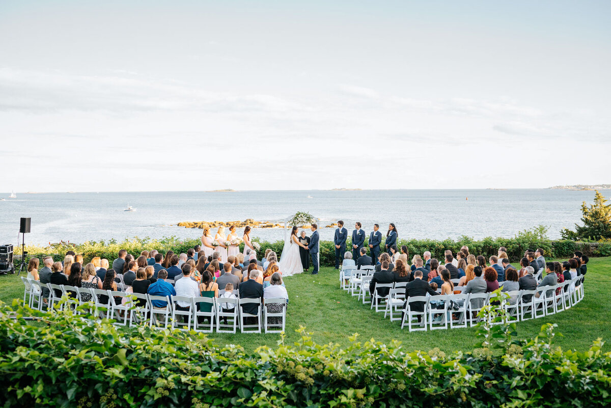 wedding ceremony by ocean at misselwood at endicott college