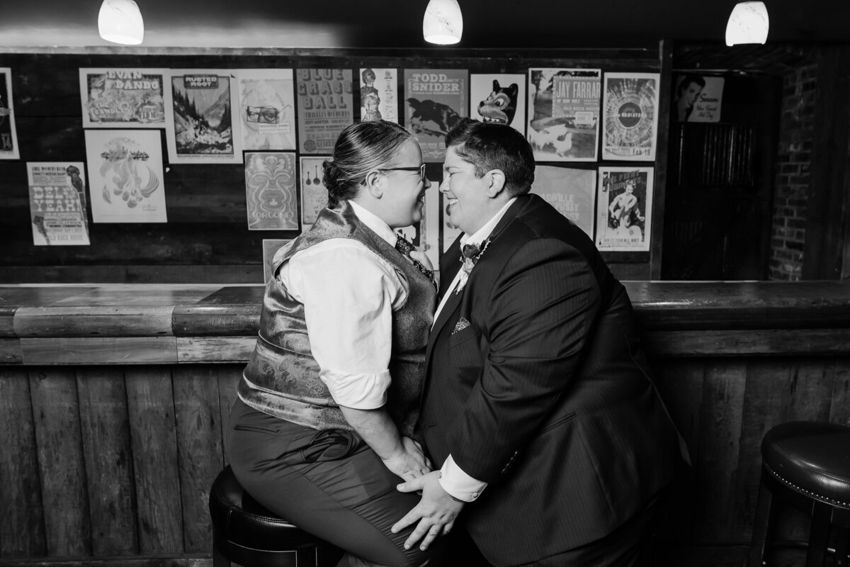 Couple laughs together sitting at the bar at The Old Rock House in St. Louis