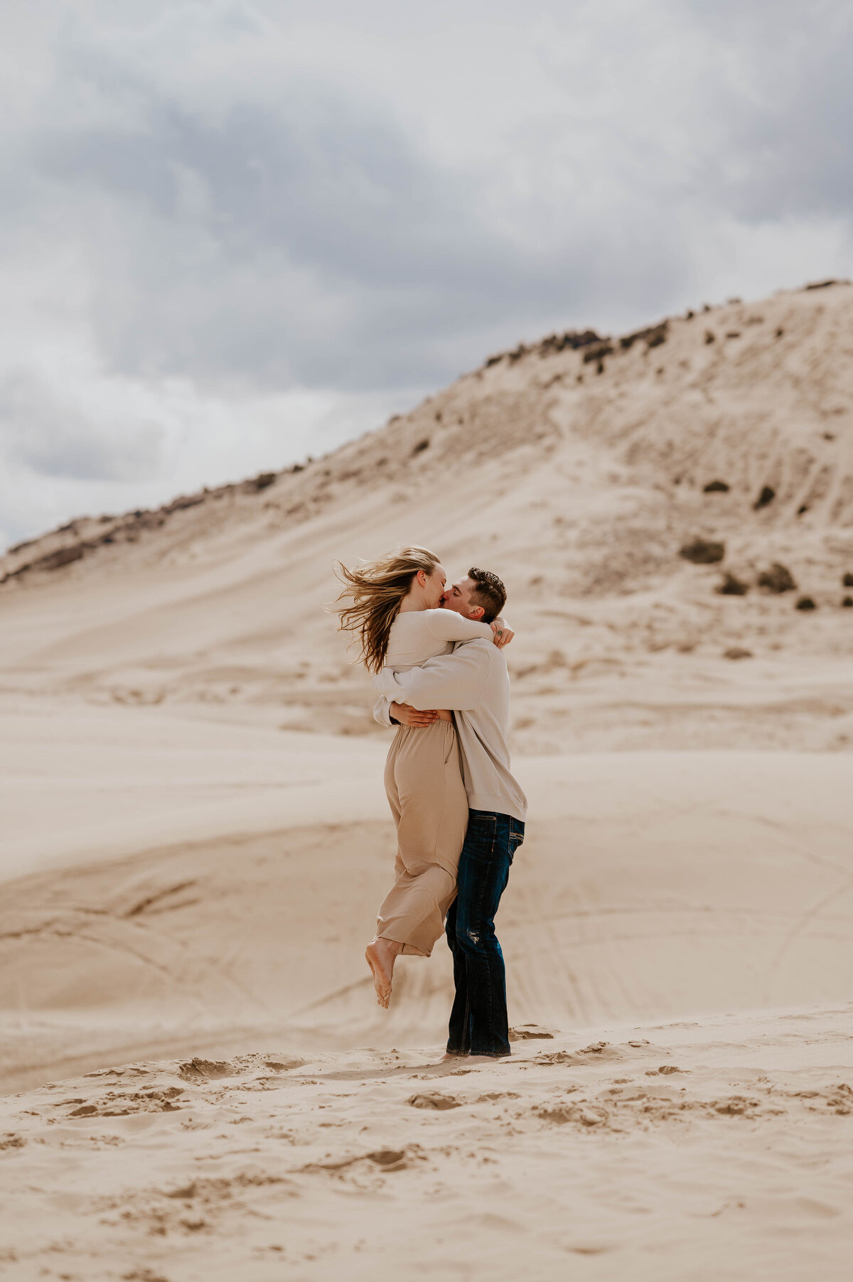 Couple embracing in Alberta sanddunes 