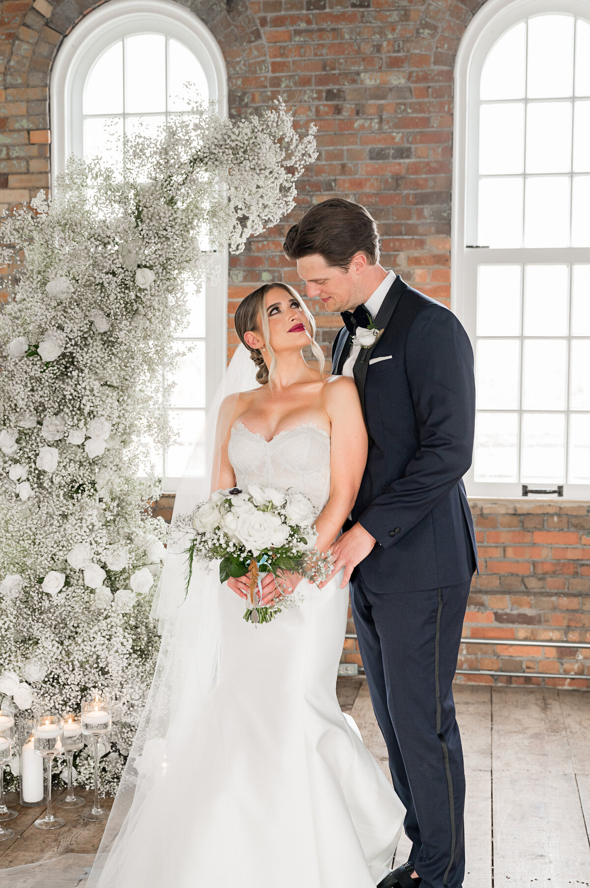 bride and groom with arch by fox and the fleur on wedding day at the pump house rivers of steel
