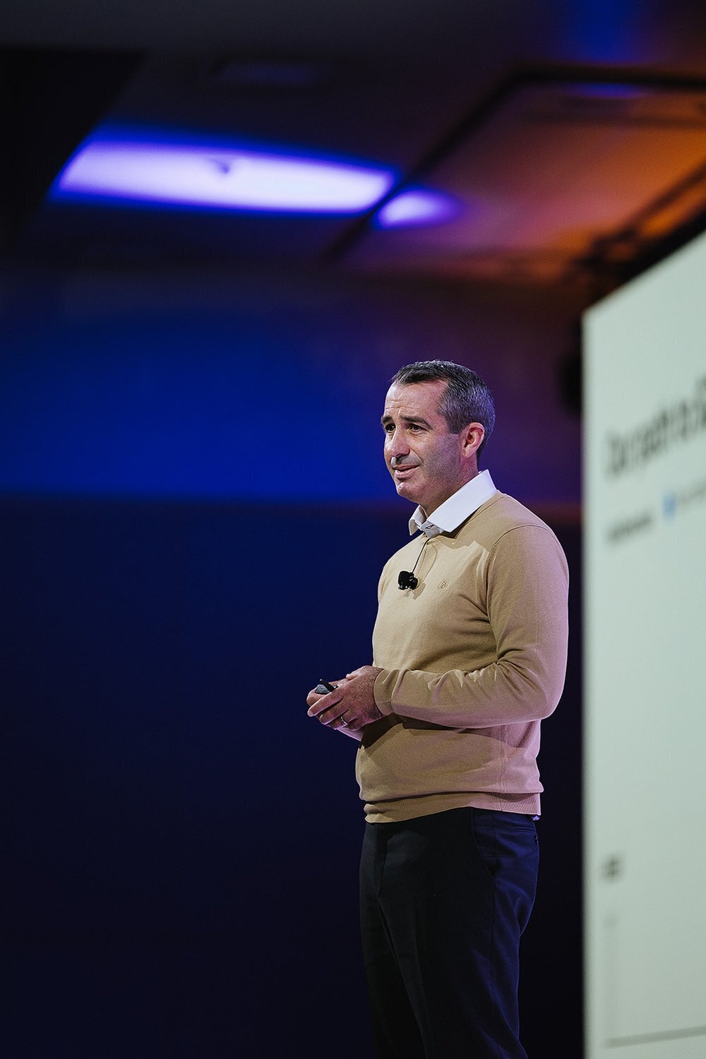man on stage as a key note speaker 