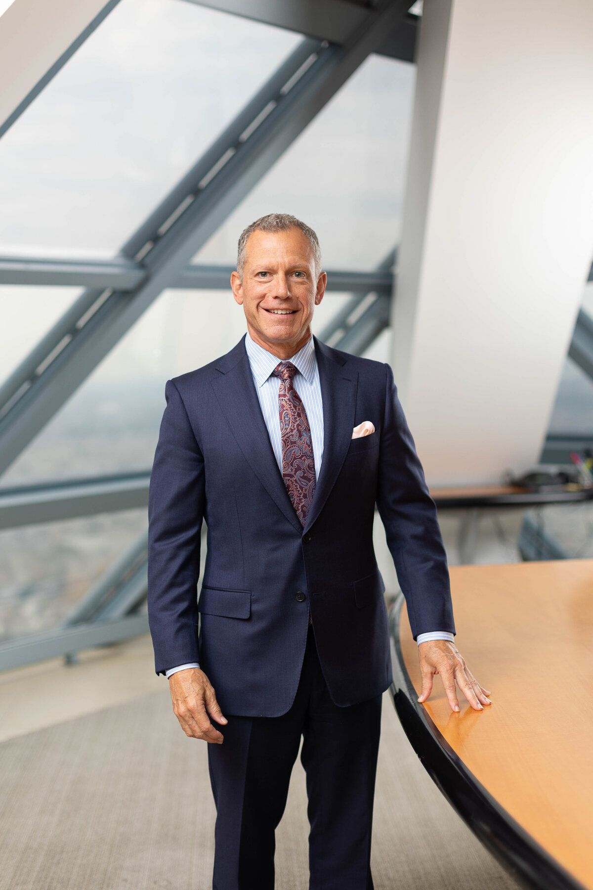 Attorney in a custom suit, standing in highrise