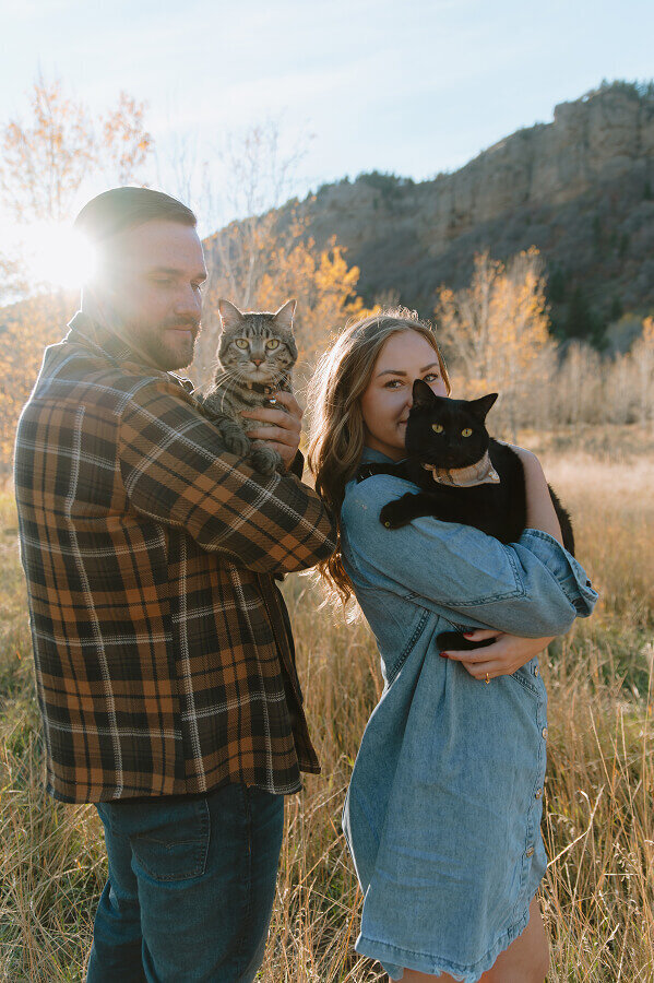 A man and woman each hold one of their cats during their couples shoot in Swan Valley.