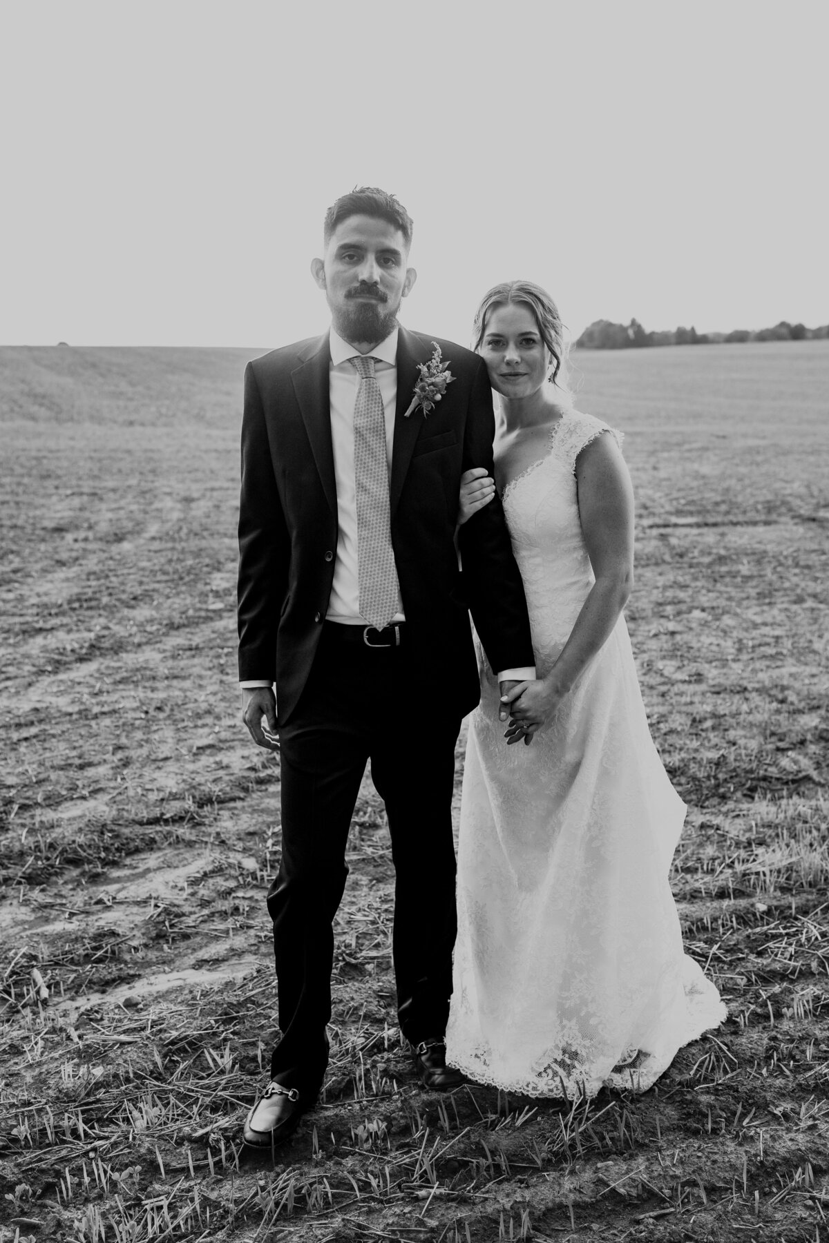 Bride and groom in field in Wisconsin