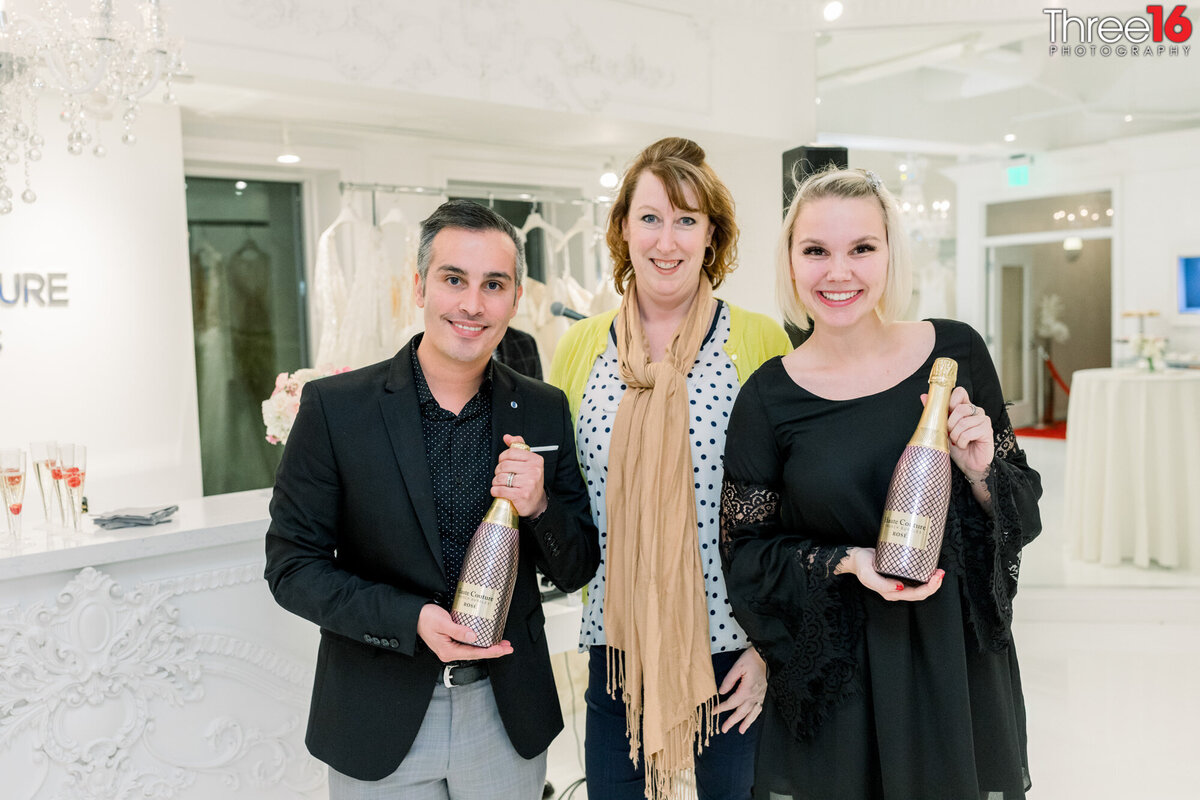 Dress shop owners celebrate grand opening with champagne