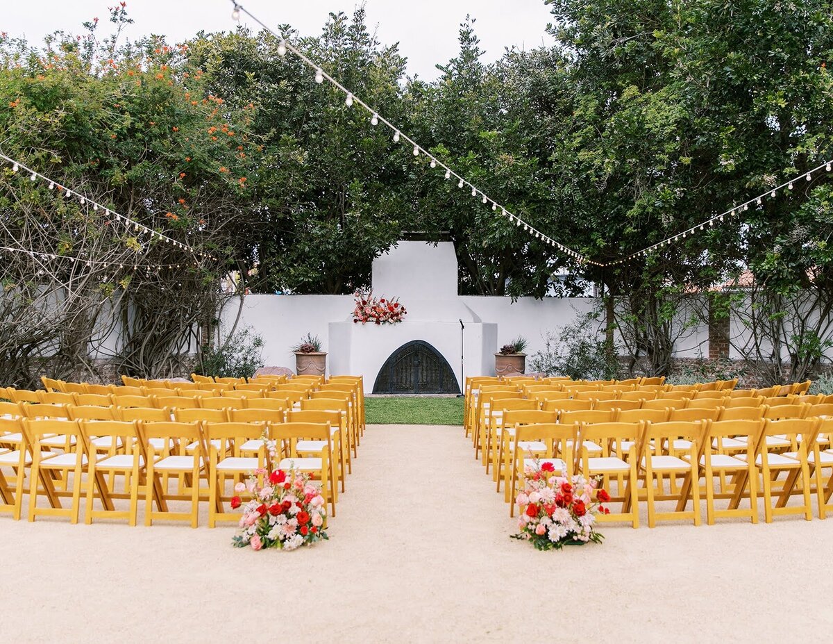 Colorful wedding ceremony with pink and red flowers at The Casino San Clemente