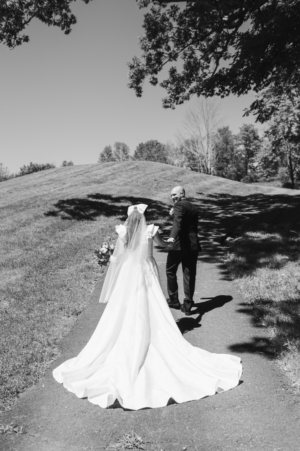 walking from behind photo of the bride train