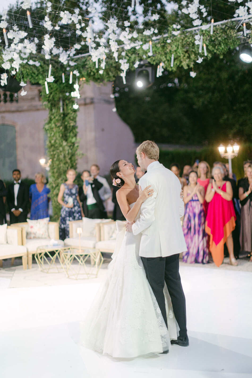 Bride and groom’s first dance under hanging flowers and candlelight at a Provence wedding.