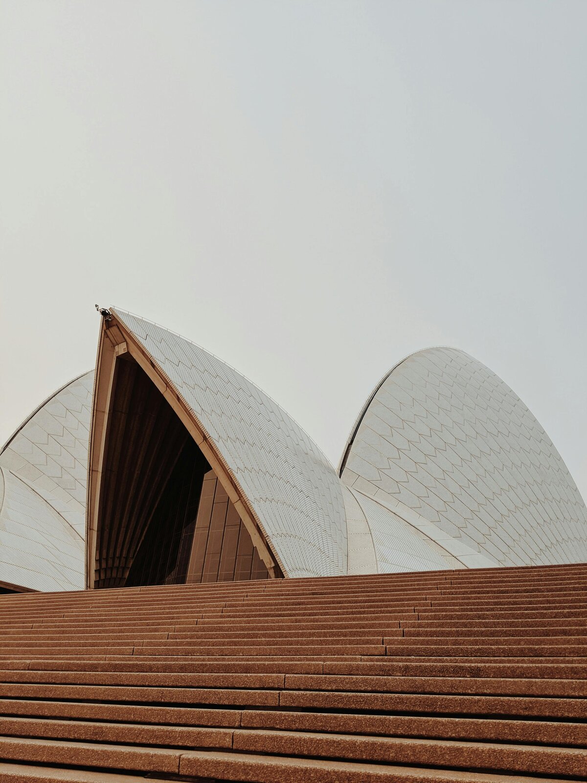 Close-up view of the iconic Sydney Opera House sails and front steps.