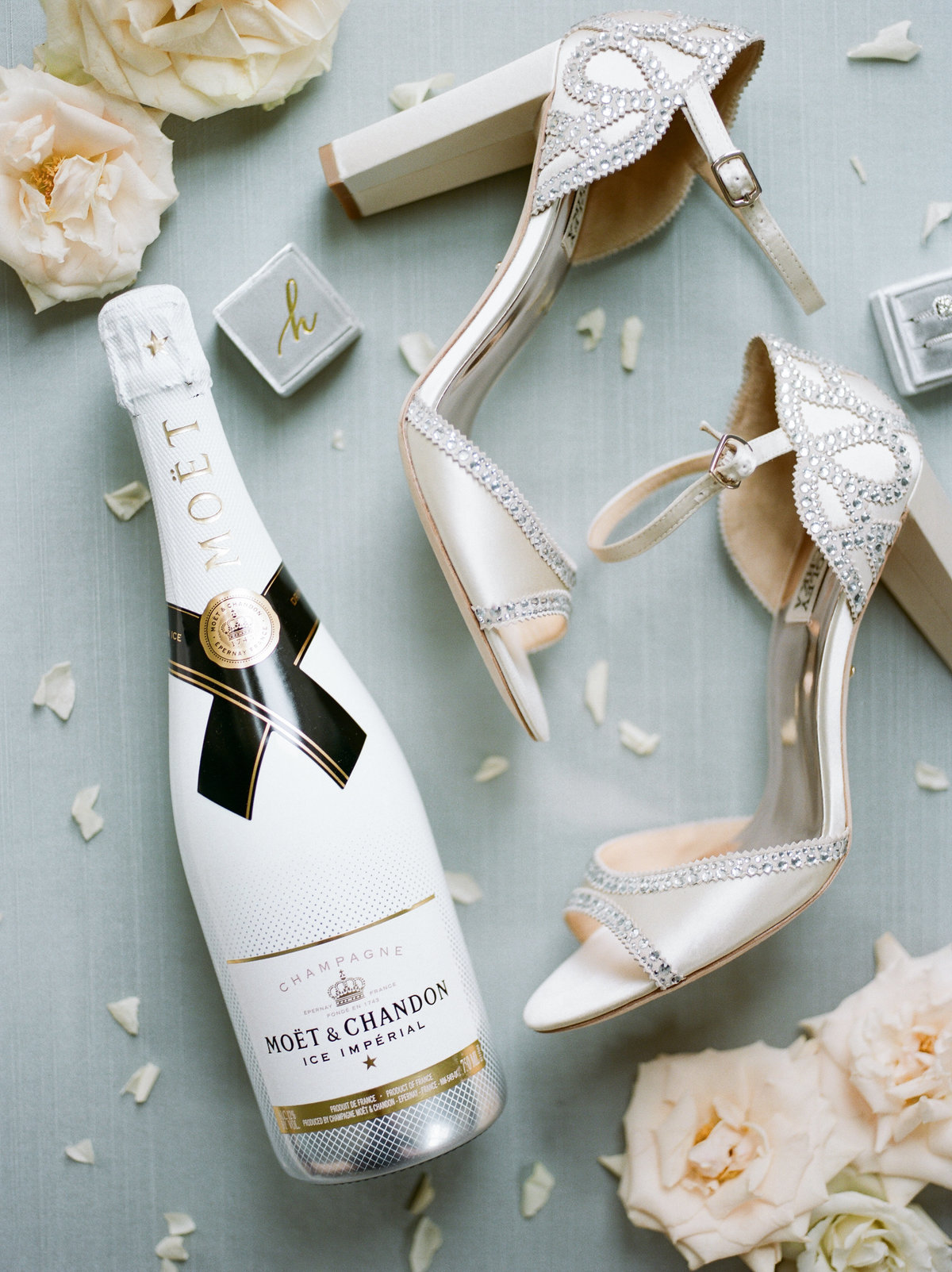 bridal shoes, florals, and champagne bottle for details shot
