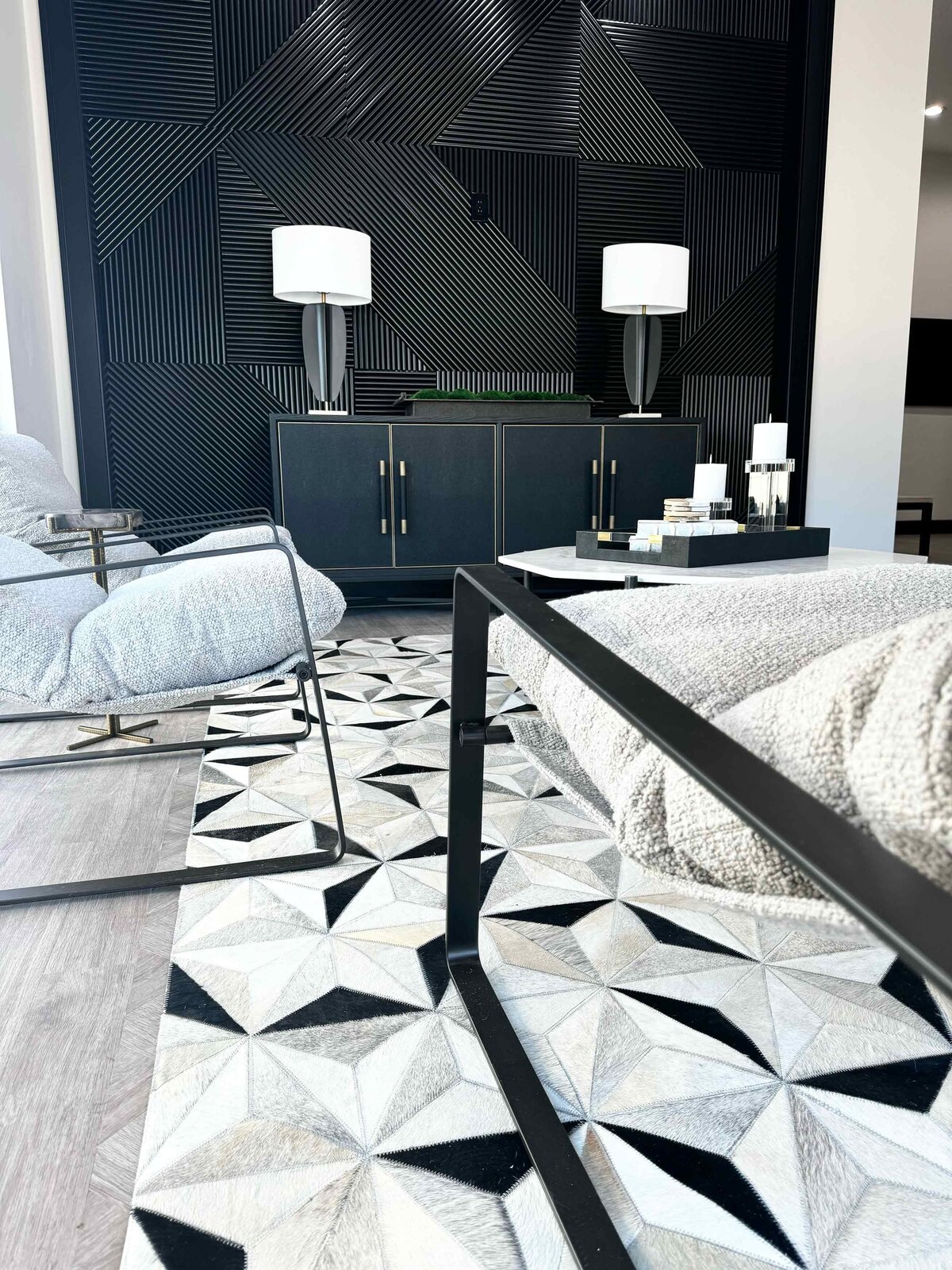 Custom interior design and renovation featuring a close-up of a unique black and white carpet in a living room, highlighting the stylish and modern décor elements.