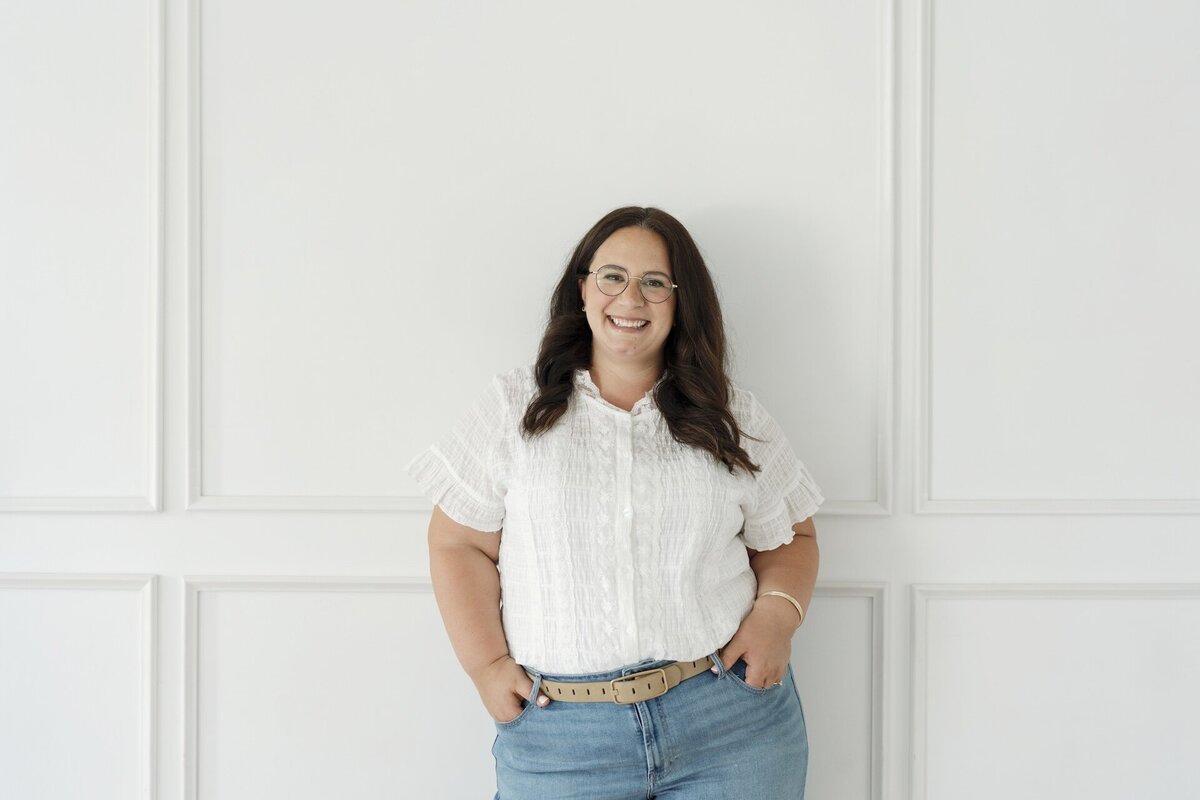 Cat smiling in front of a wall with white wainscoting