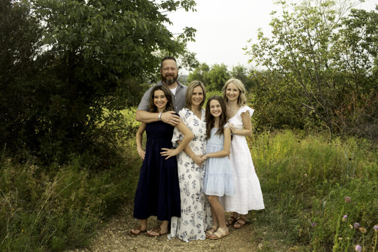 Fun and laughter fill the air as the family shares a joyous moment during their playful, energetic photoshoot