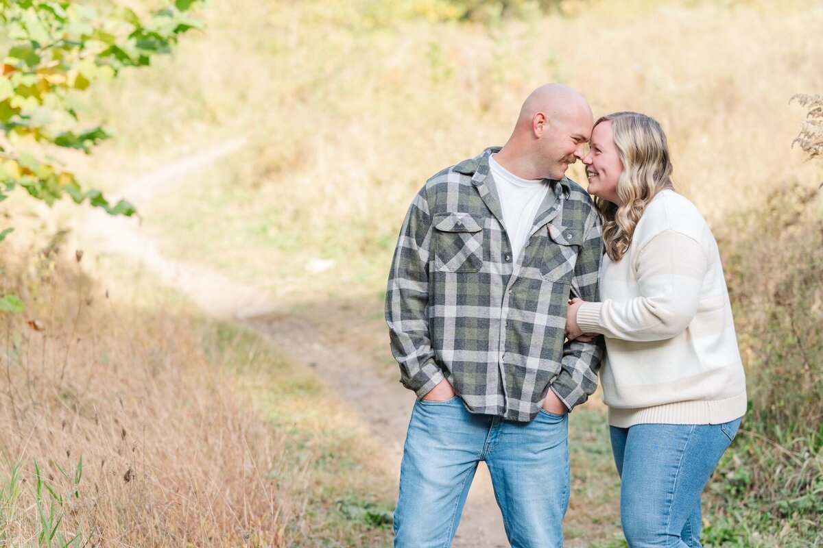 an engaged couple touching foreheads