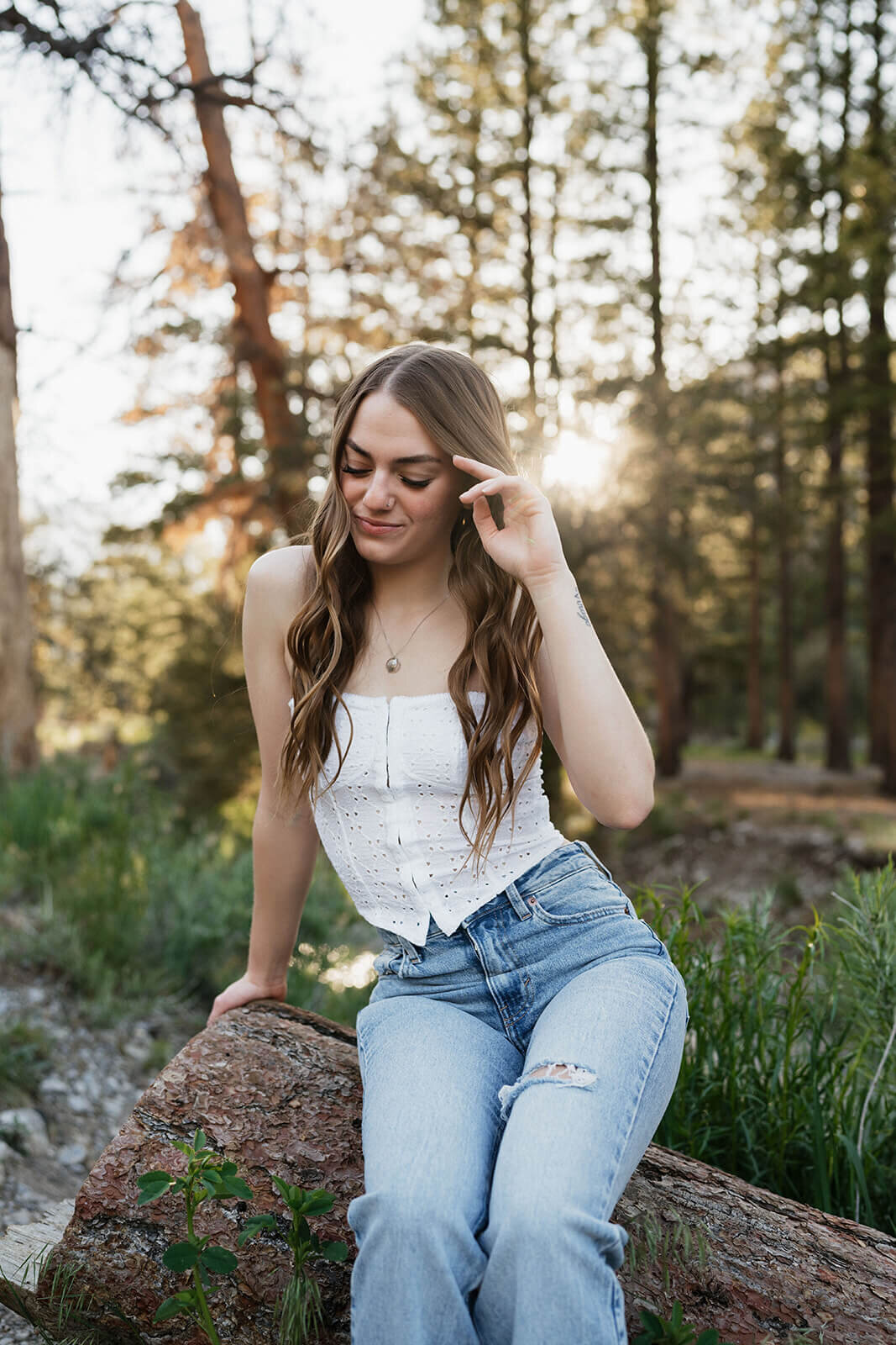 Senior-session-bending down in forested area-Rachel-Murray
