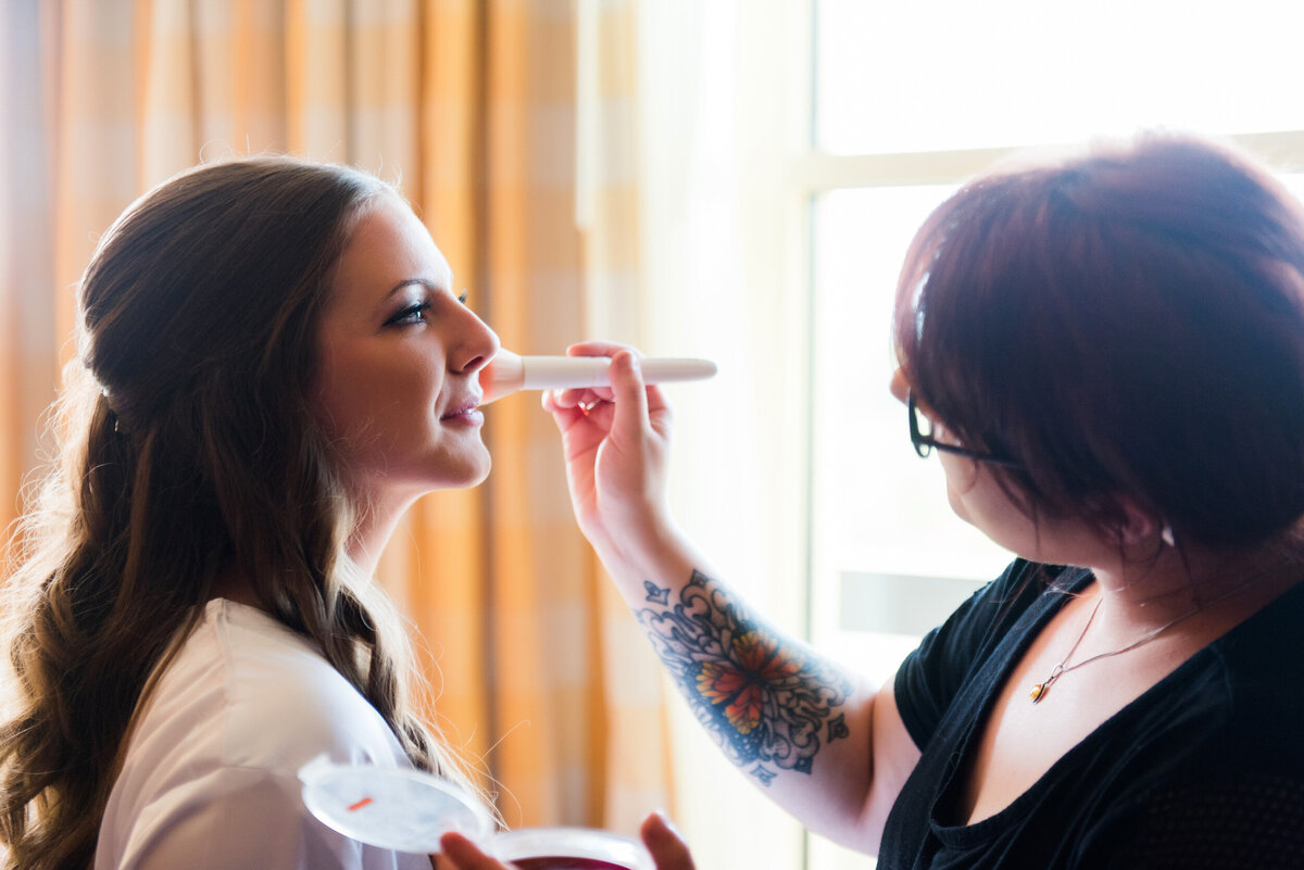 bride getting her makeup done before her oglebay resort wedding
