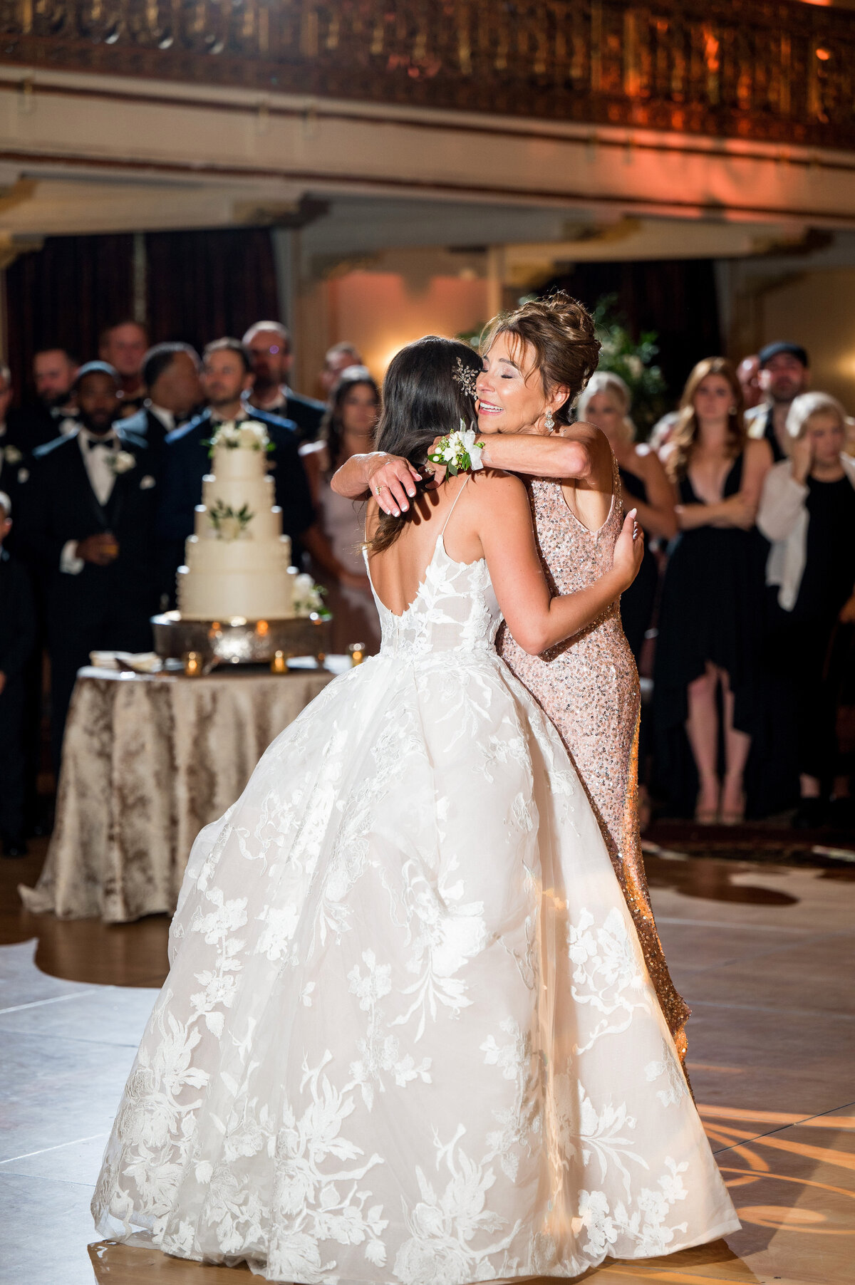 bride and mom hugging at wedding reception