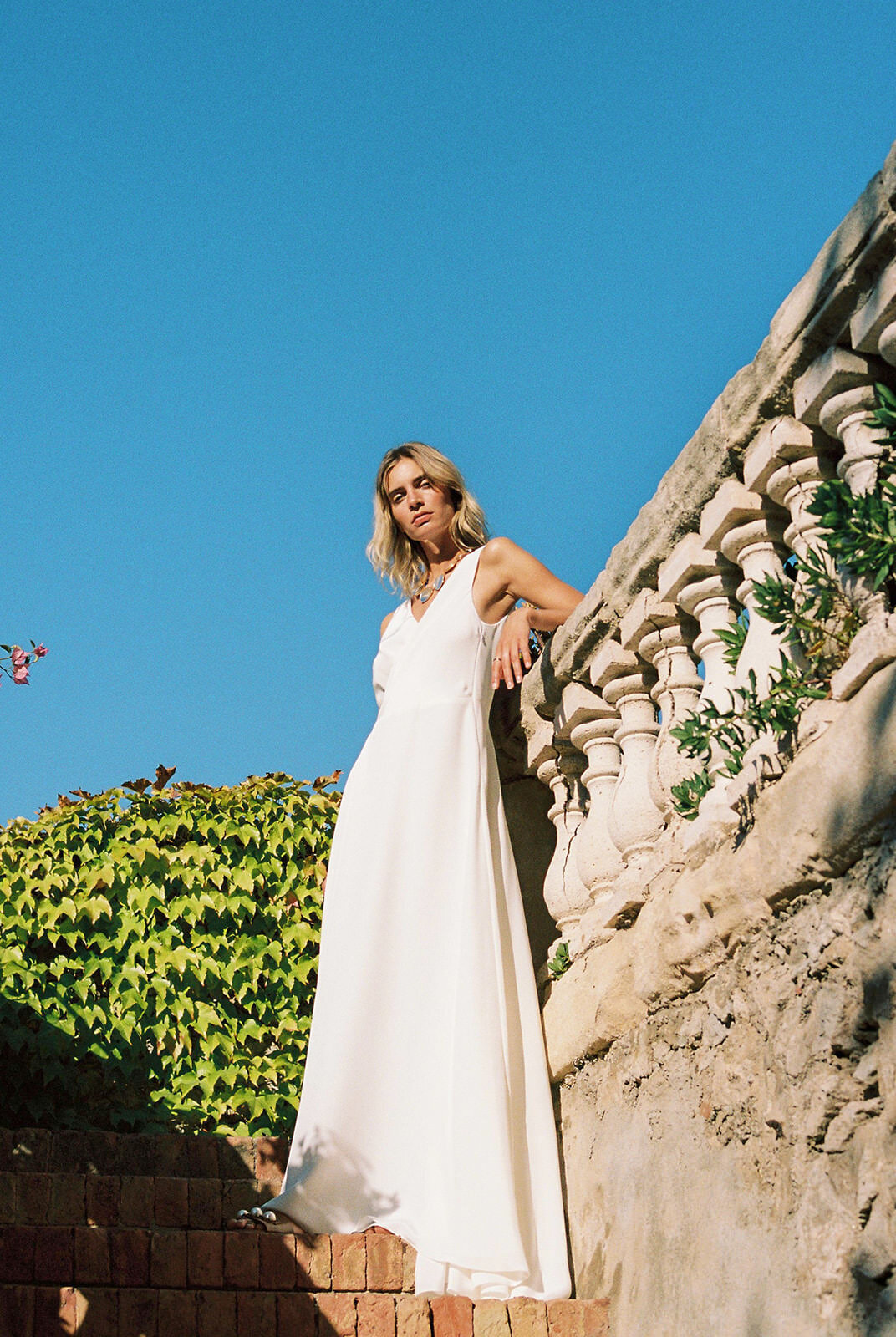 Long, flowing silk wedding dress with v neck design by British bridal gown designer