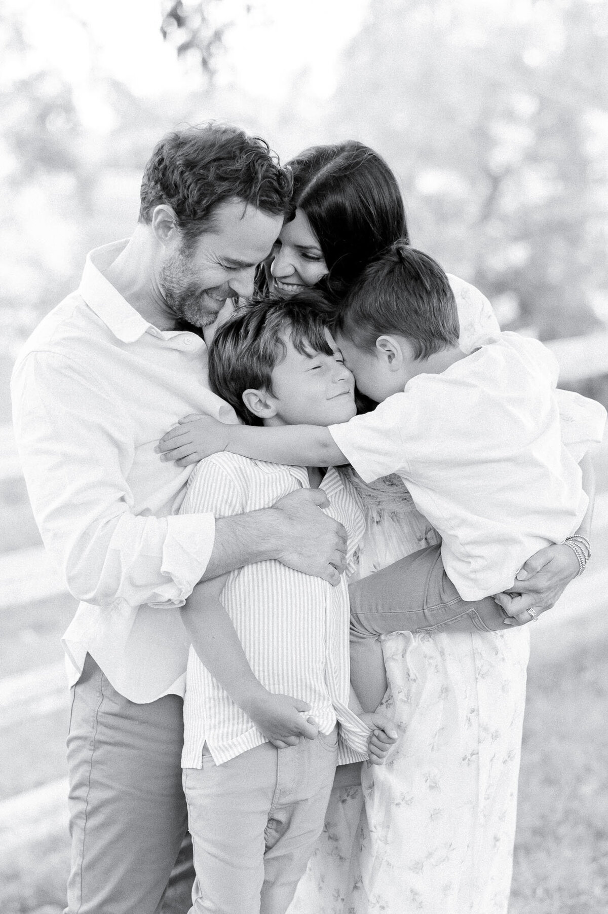 Black and white image of a family hugging