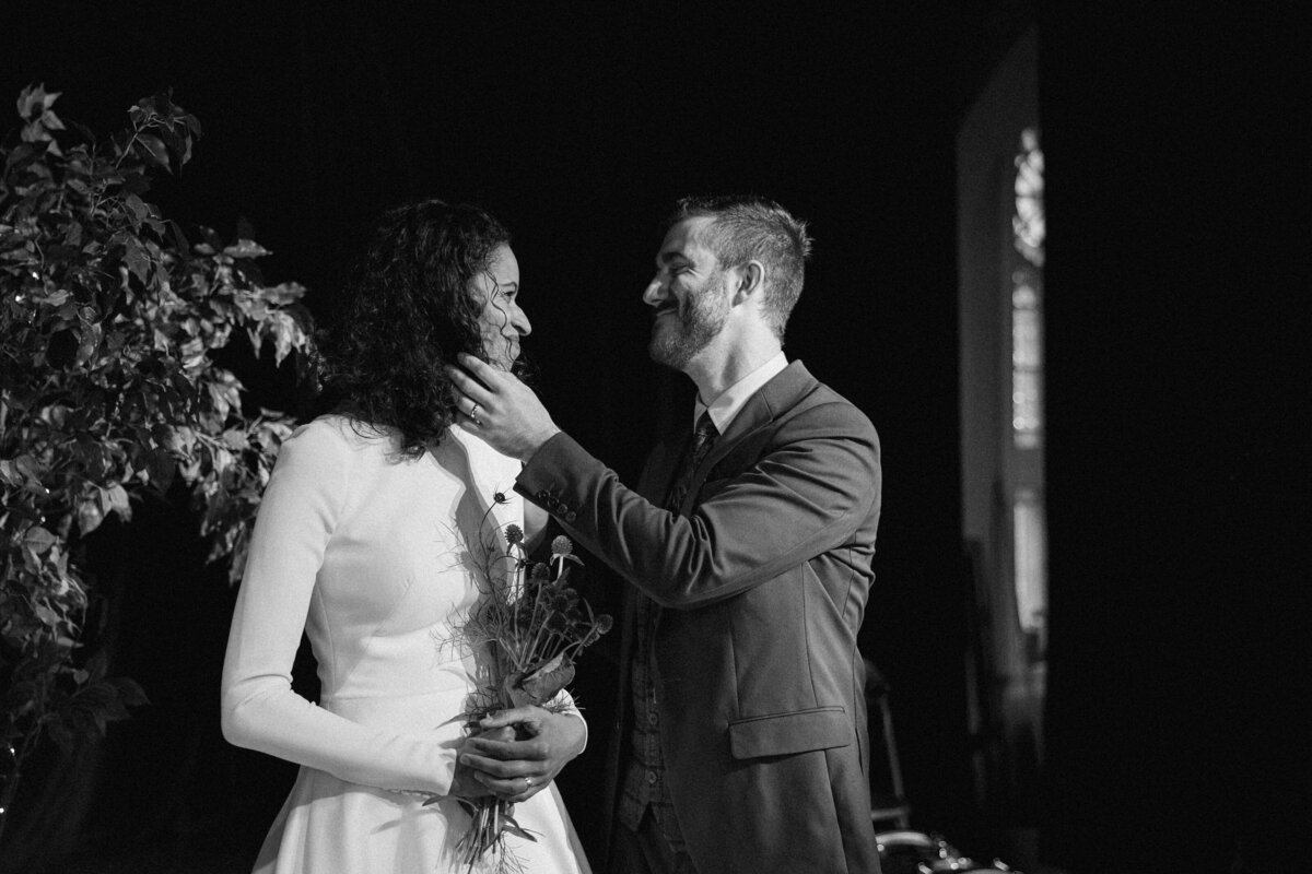 Bride and groom shares a fond smile for their wedding portrait