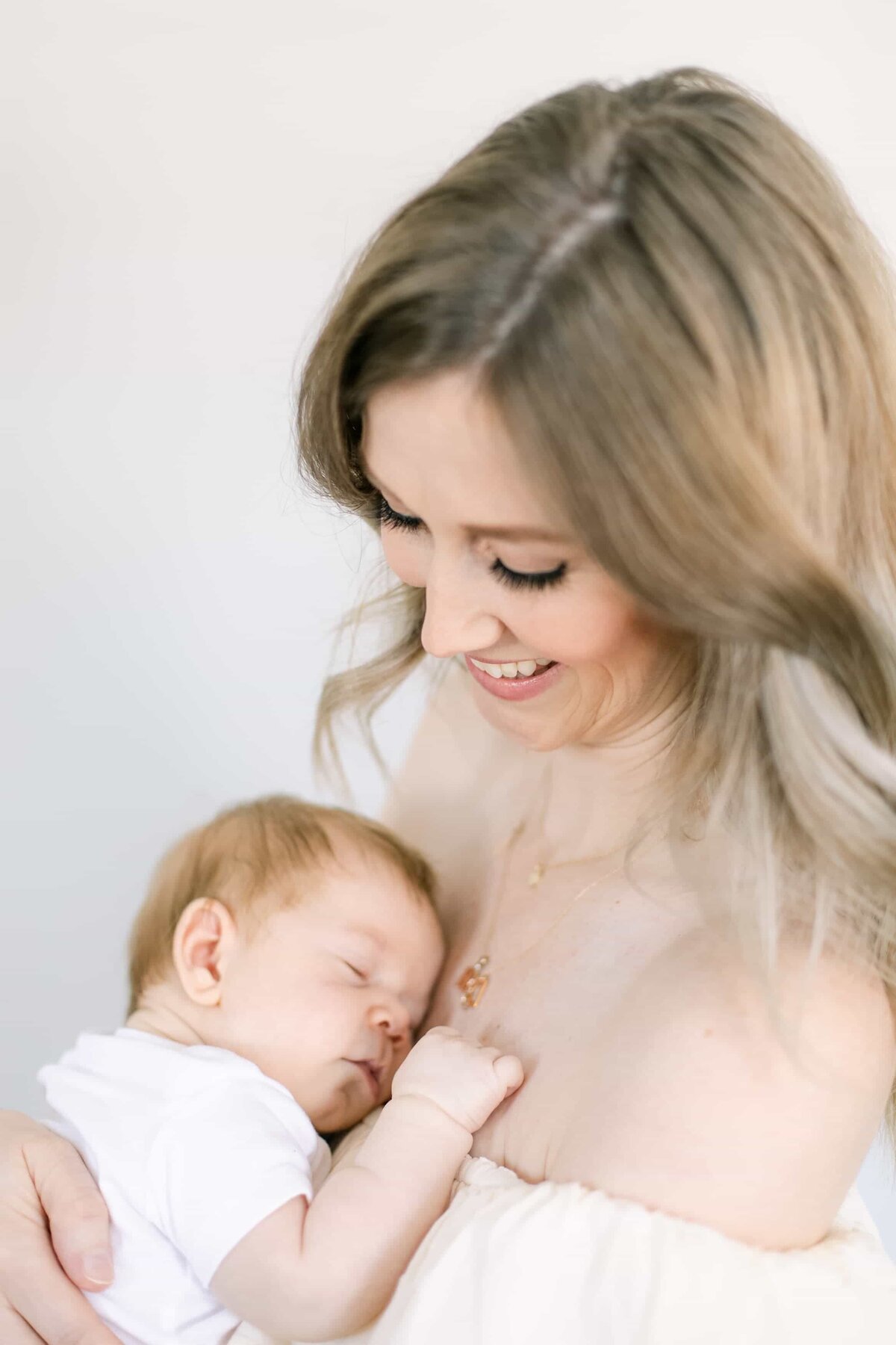 Orange County Newborn Photographer - baby on mothers chest during inhome newborn session