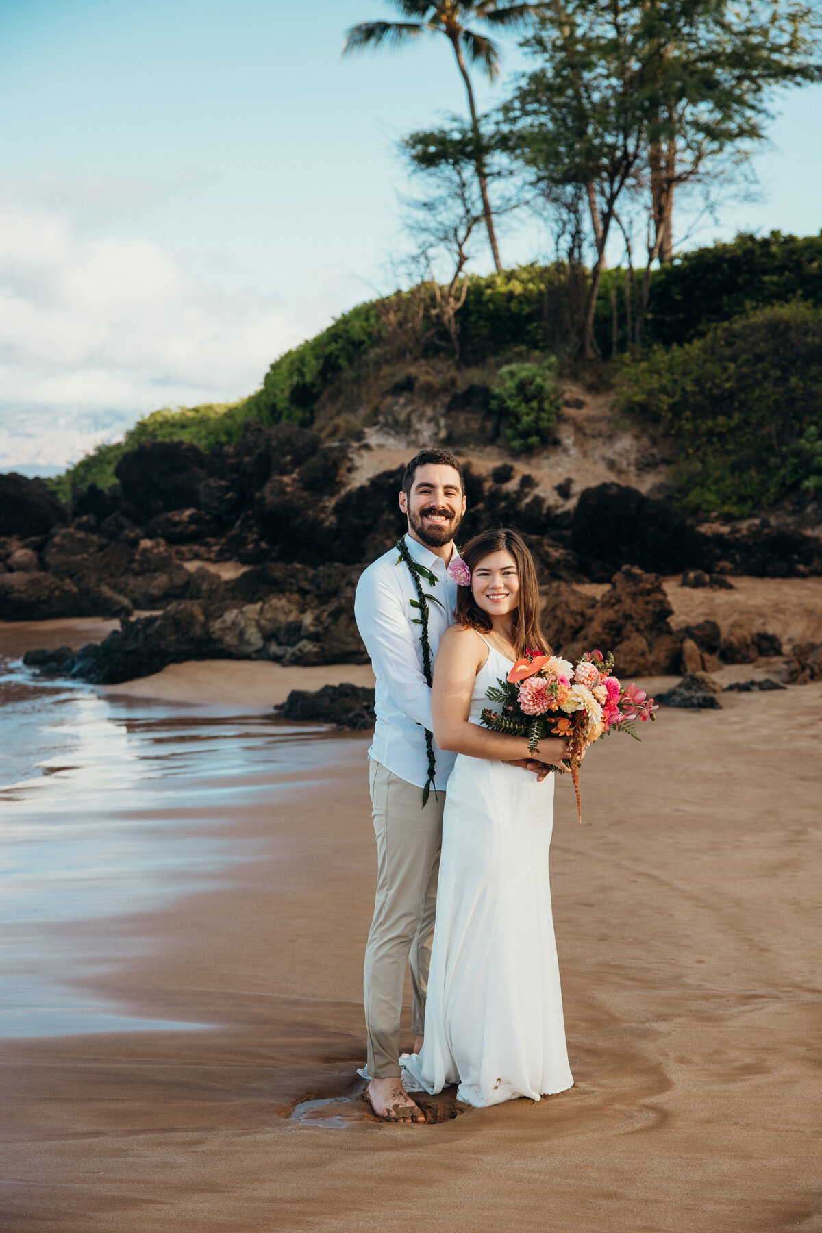 Maui Wedding Photographer captures groom holding bride on beach