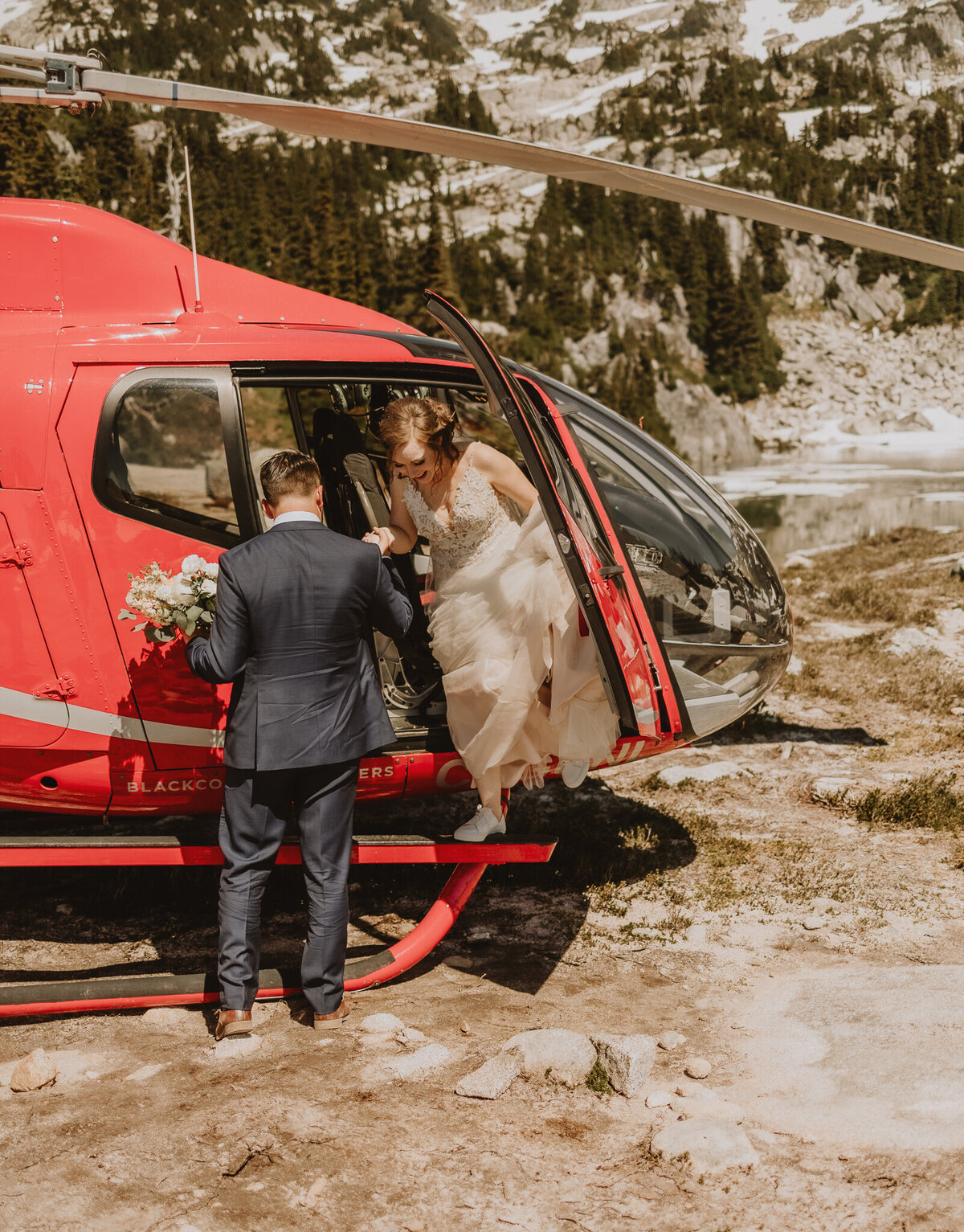 Couple getting out of Blackcomb helicopter in whistler, BC