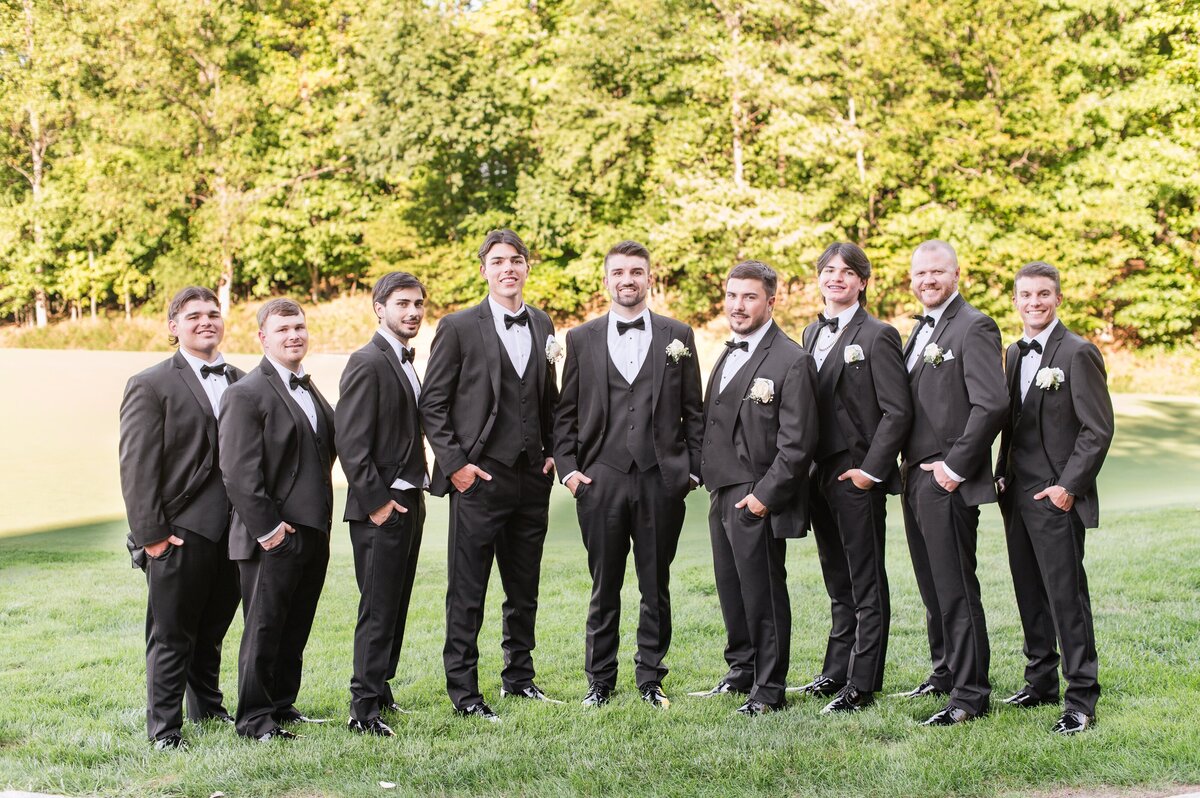 groomemen on golf course black tuxedos