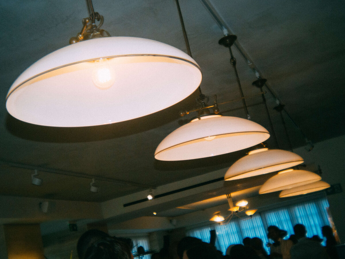 Stylish ceiling lights in wedding reception space at Soho House Rome

