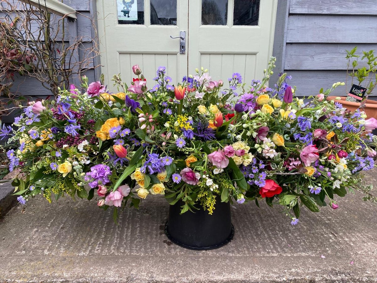 Casket spray of colourful flowers