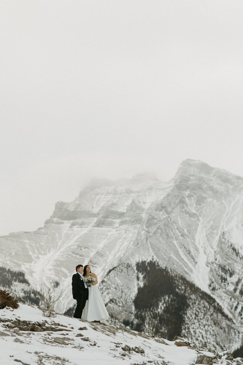 banff elopement photo of couple on mountain in winter