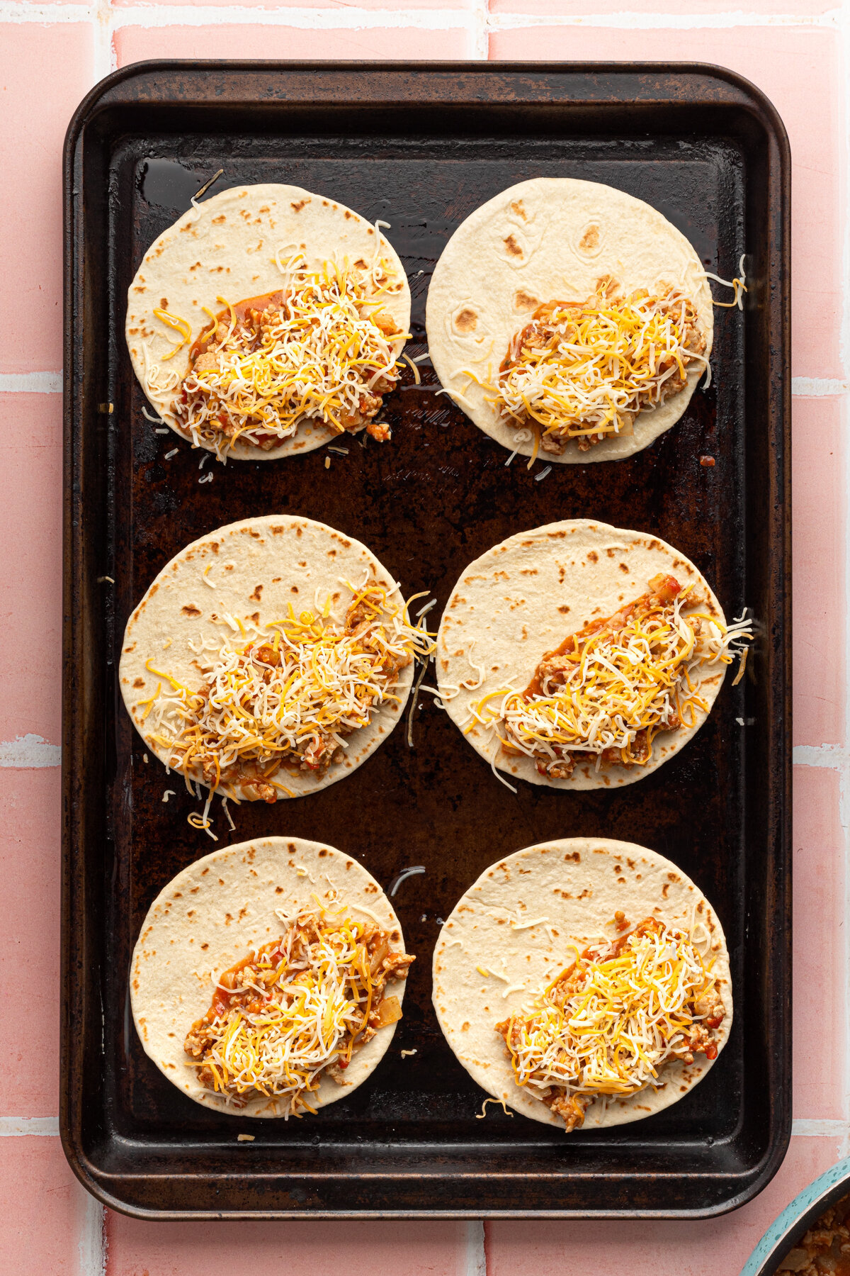 soft tortillas topped with taco ingredients