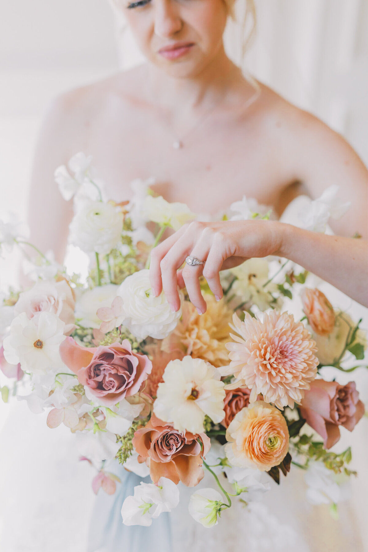 Bride showing ring with bouquet - ©Jess Palatucci