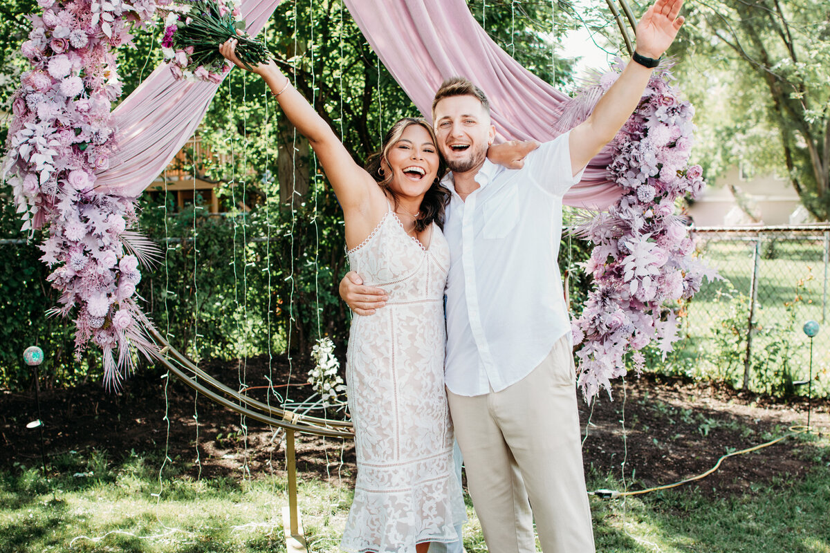 Just married bride and groom surrounded by greenery in Streamwoood, IL