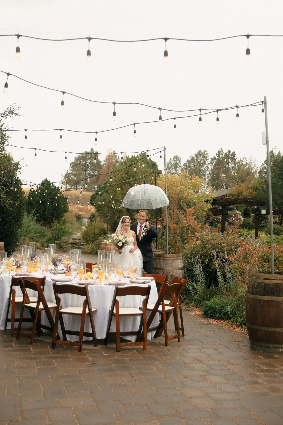 Bride and Groom Walking Through Rainy Vineyard Reception | Oregon Wedding Photographer