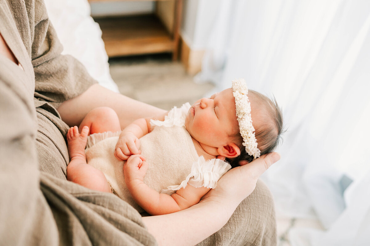 Springfield MO newborn photographer captures sleeping baby girl in moms arms