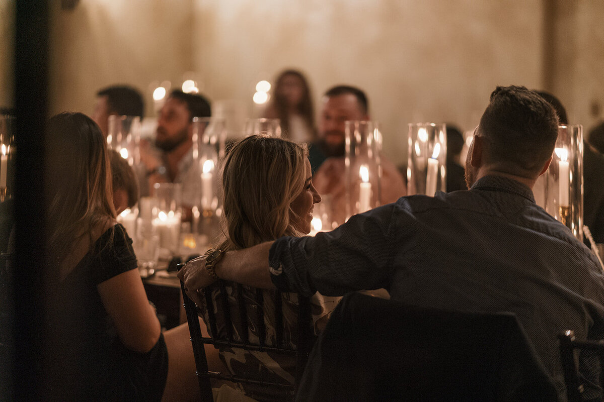 bride smiling at wedding reception candlelight
