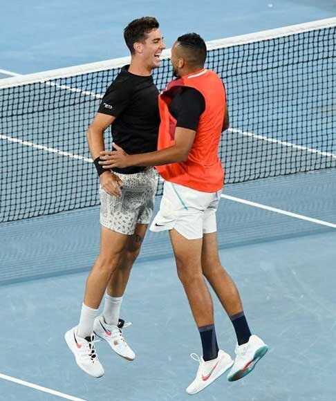 Australian Open male doubles tennis players celebrating point with mid-air chest bump