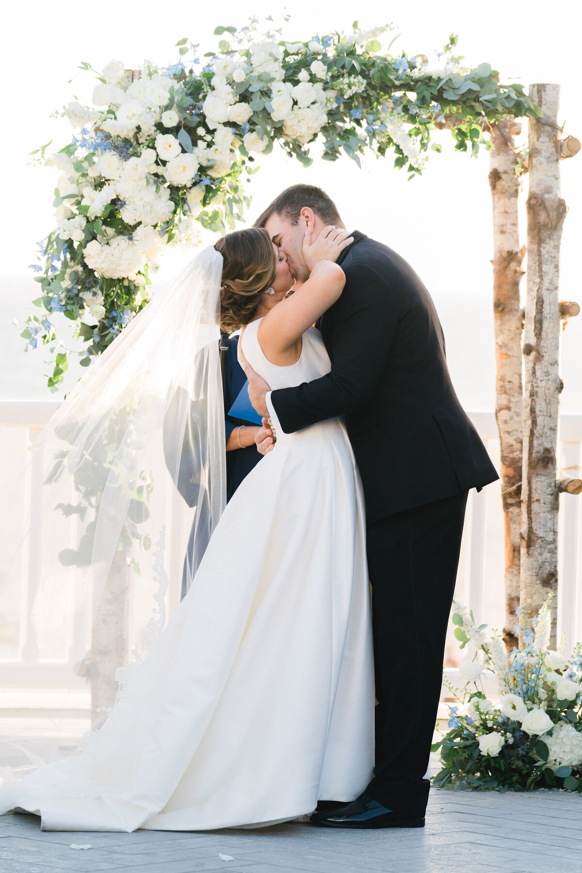 bride and groom are kissing now as husband and wife