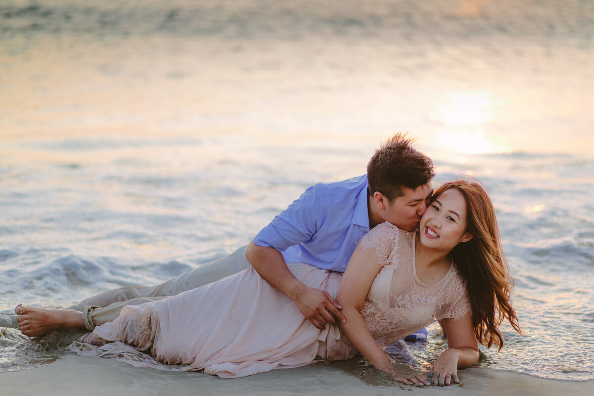 couple reclining in shallow ocean