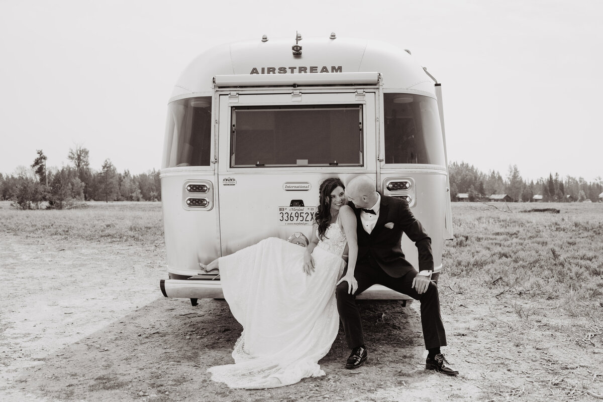 Jackson Hole photographers capture groom kissing bride's shoulder